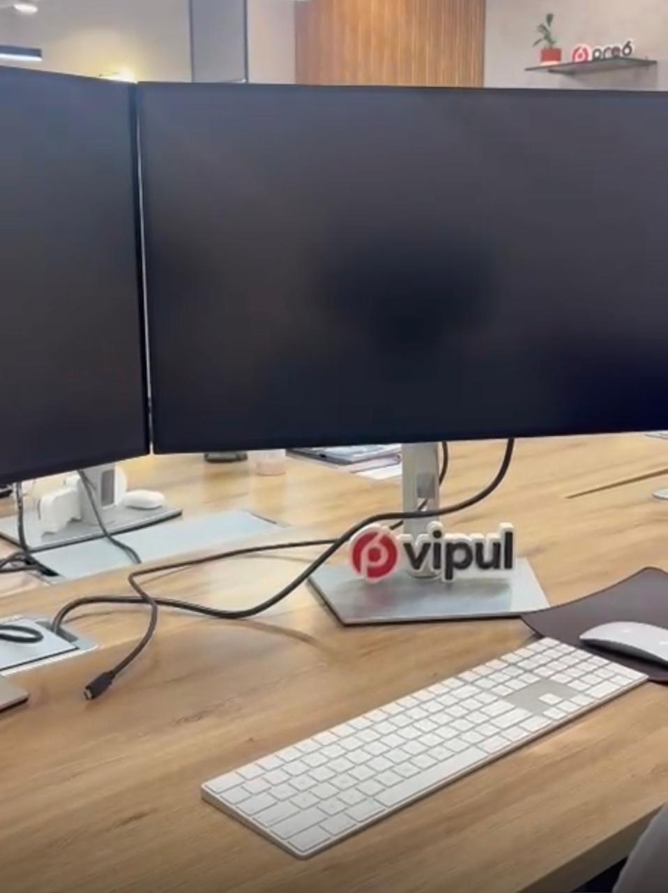 Branded desk name sign placed at an office workstation